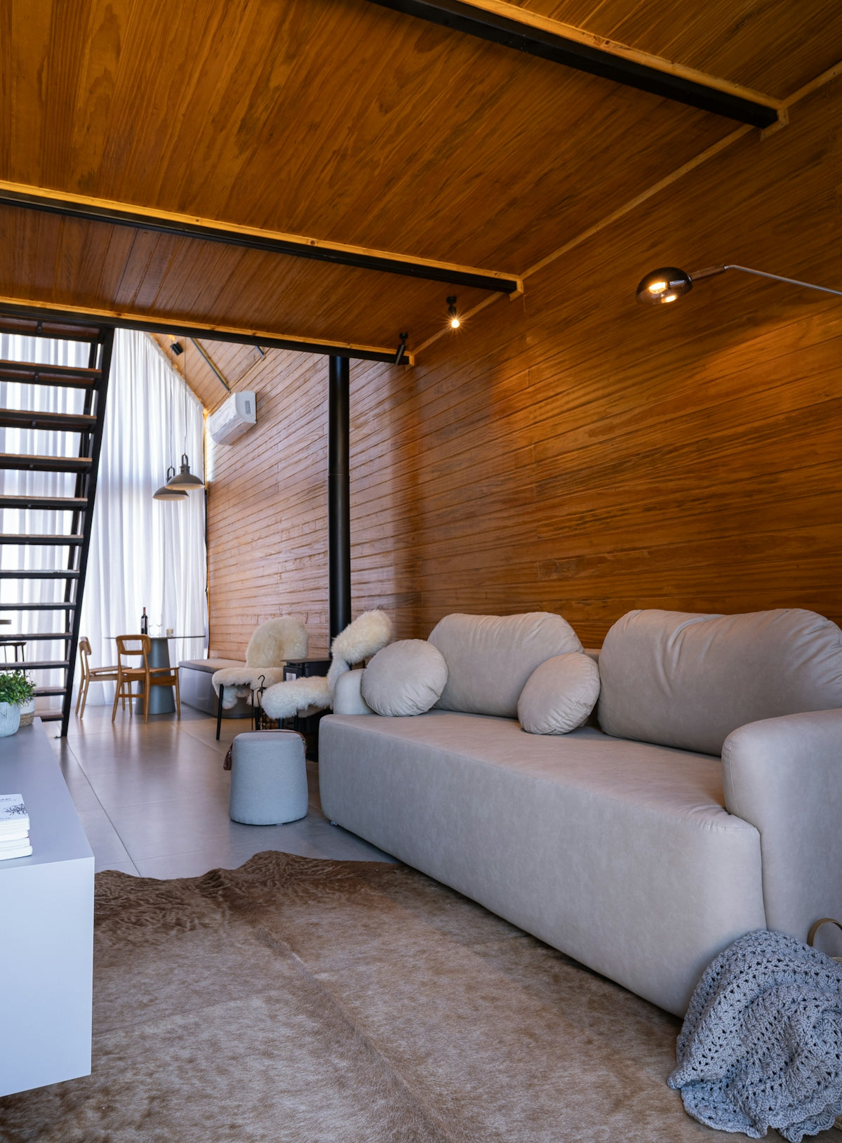 Modern living room with wood paneling and sofa.